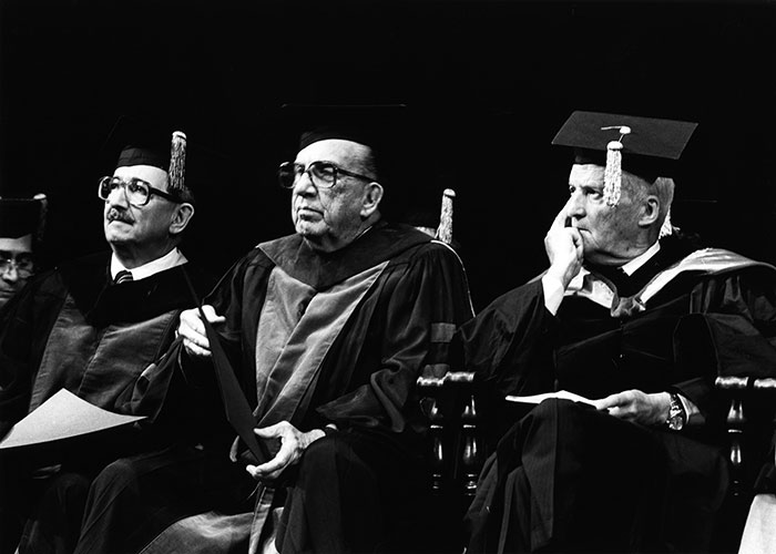 Dr Juan Enrique Morales y Dr Juan Rossello, recibiendo distinción de Profesores Emeritos, con el Dr. Luis Leloir, premio Nobel de Química, recibiendo Doctorado Honoris Causa de la UPR, RCM 1983